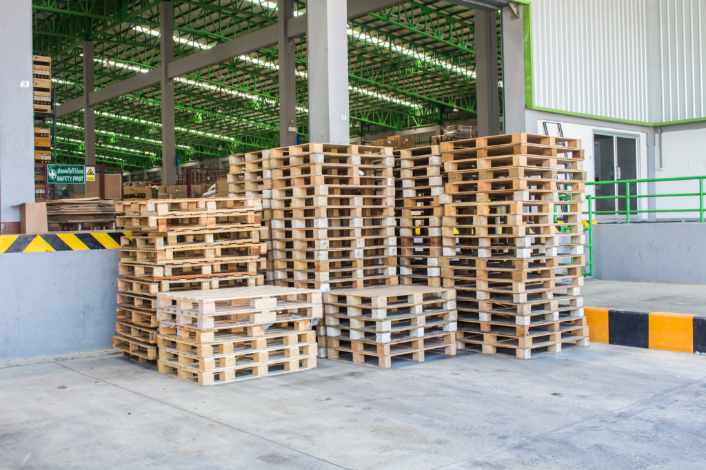 Stacked-Up-Wood-Pallets-Sitting-Outside-a-Garage-At-a-Commercial-Business